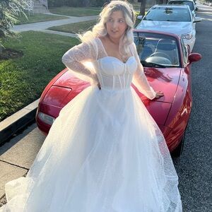 Elegant White Sparkle bridal ball gown with long sleeves and train